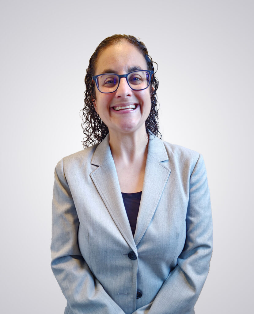 Smiling brown haired woman in front a white background -Marissa Horowitz