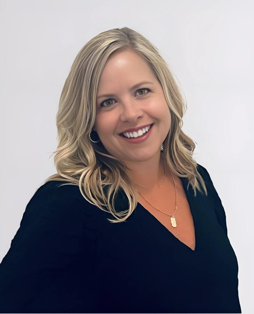 Professional headshot of a blonde haired woman smiling and white shirt - Heather Schwanke